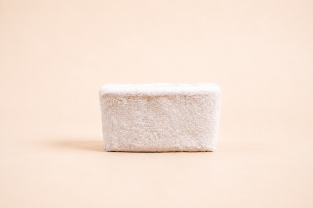 Small rectangular basket, plush white fur, straight view